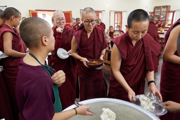 Tibetan Buddhist nuns getting rice at Dolma Ling Nunnery