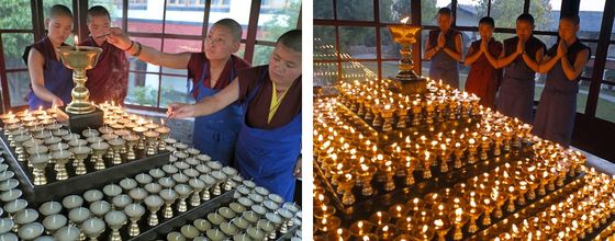 Tibetan Buddhist nuns lighting butter lamps