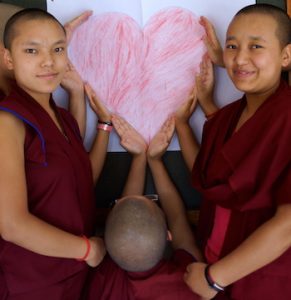 Tibetan nuns holding heart