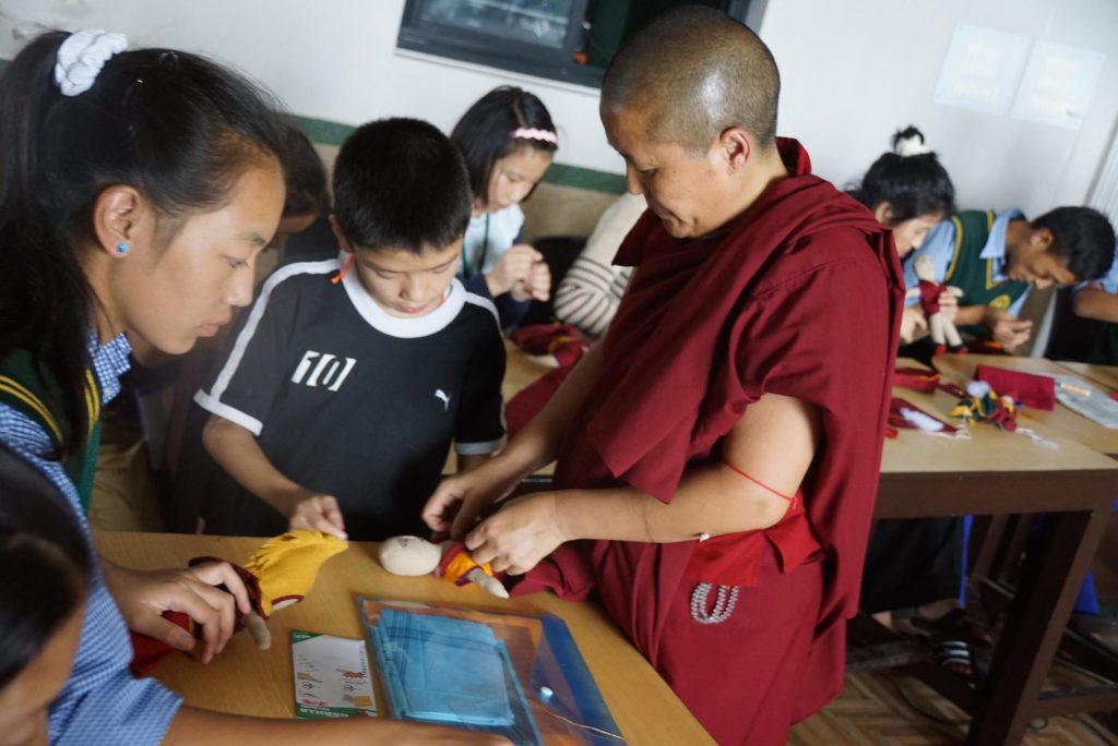 Tibetan Buddhist nun at workshop for students