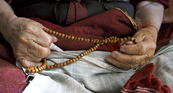 Buddhist nun holding Tibetan mala