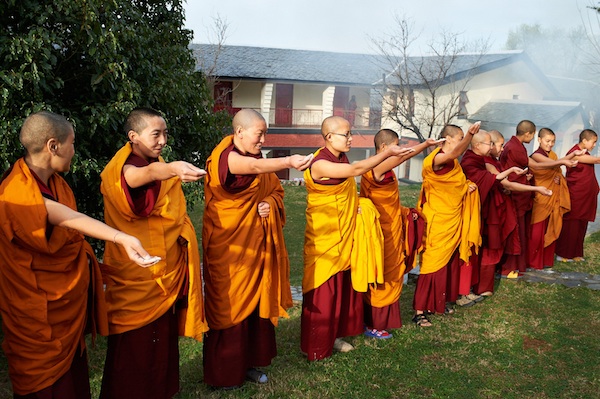Buddhist nuns throwing tsampa at Losar