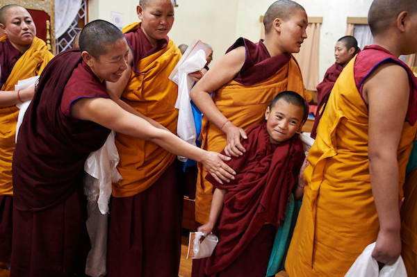 line of nuns offering khatas at Losar