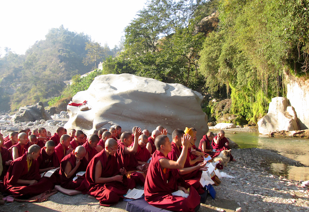 Buddhist nuns worship near cave of Tilopa