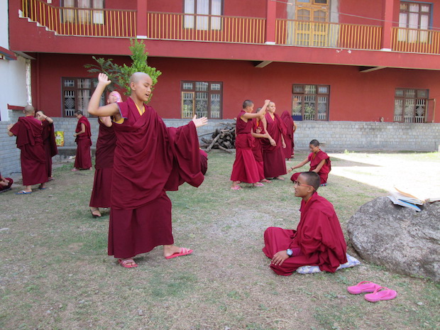 Tibetan Buddhist nuns debating outside the nunnery