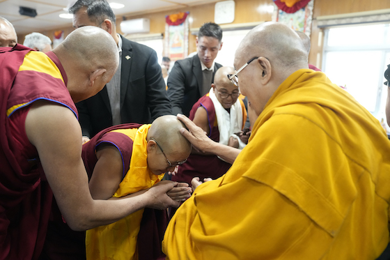 A Tibetan Buddhist nun receives a blessing from His Holiness the Dalai Lama Dec 2024