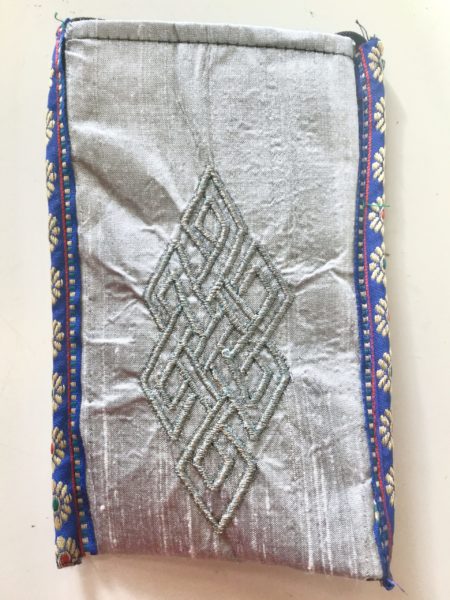 Cell Phone Holder_Gray Cell Phone Pouch Gray protects your phone, eyeglasses and other small valuables with a unique crossbody strap and embroidered eternal knot symbol at its center, handmade by Tibetan Buddhist nuns