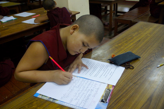 Tibetan Buddhist nun writing an essay