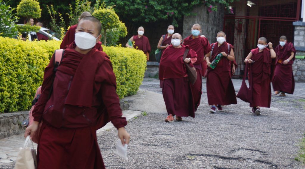Tibetan nuns at Dolma Ling leaving to get vaccinated