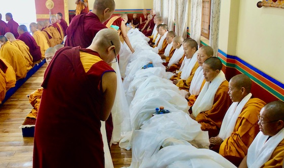 Graduating nuns at Shugsep Nunnery and Institute surrounded by mountains of kataks at their graduation ceremony on October 2022.