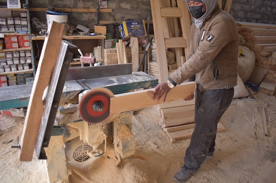 A carpenter making wood panelling for Sherab Choeling