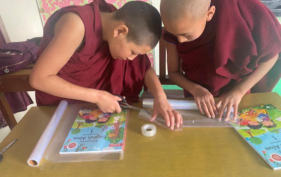 Nuns at Geden Choeling nunnery carefully protect their new textbooks