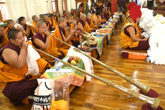 Nuns playing Tibetan long horns or dungchens