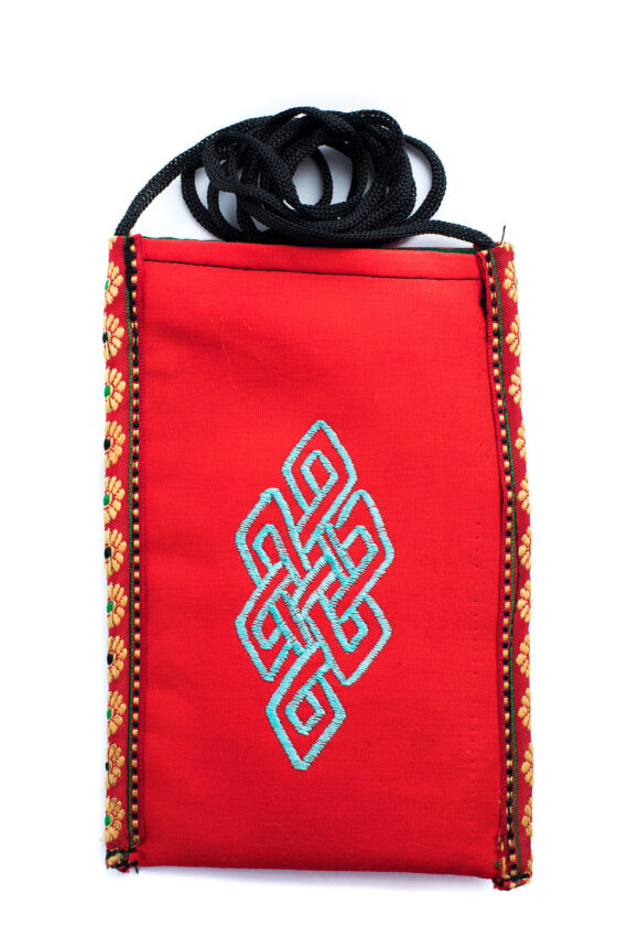 Cell Phone Pouch Cell Phone Pouch Red protects your phone, eyeglasses and other small valuables with a unique crossbody strap and embroidered eternal knot symbol at its center, handmade by Tibetan Buddhist nuns