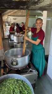 Tibetan Buddhist nun cooking by Robin Groth