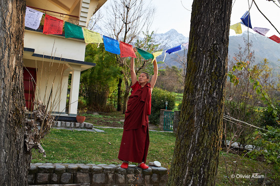 Tibetan Buddhist nun, prayer flags, hanging prayer flags