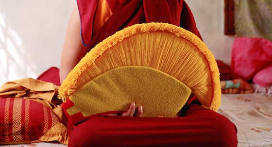 Tibetan Buddhist nun holding Geshema hat
