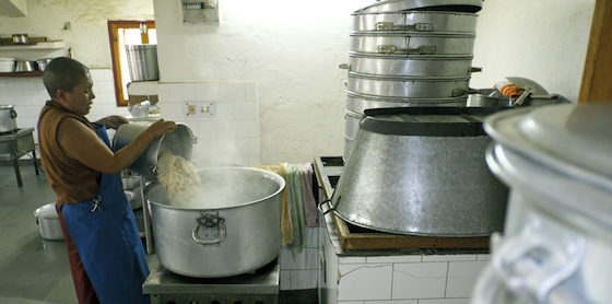 Tibetan Buddhist nun cooking rice