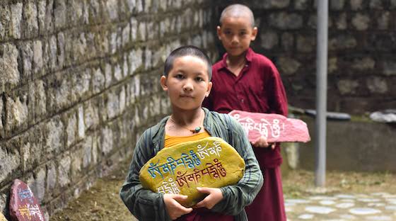 Tibetan Buddhist nuns carrying mani stones om mani padme hum