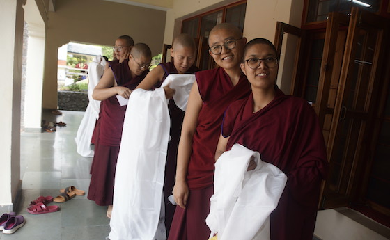 Tibetan Buddhist nuns gather outside prayer hall at Dolma Ling April 17 2025