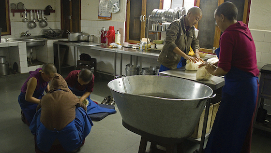 Tibetan Buddhist nuns in kitchen using flour Brian Harris copy