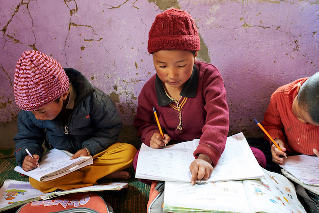 Young nuns study at Dorjee Zong Nunnery Photo by Olivier Adam