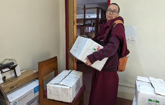 boxes of new textbooks for Tibetan Buddhist nunneries