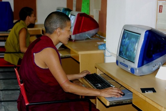 Tibetan Buddhist nun working on computer.