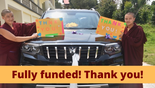 Tibetan Buddhist nuns from Dolma Ling Nunnery holding thank-you signs for new vehicle 2026