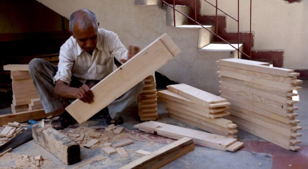 Indian carpenter making furniture at Tibetan Buddhist nunnery