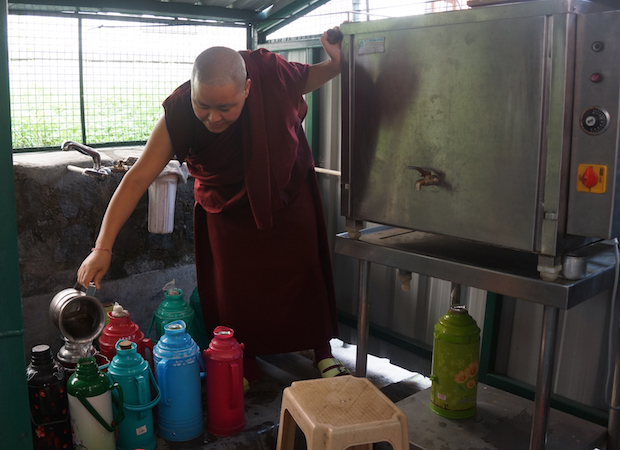 Tibetan nun filling thermoses