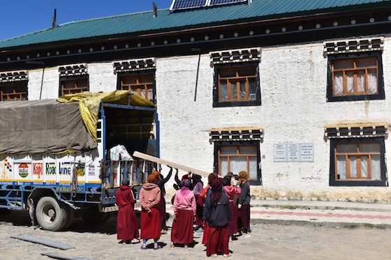 nuns unload wood for panelling project at Sherab Choeling