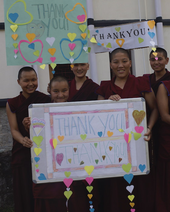Tibetan Buddhist nuns holding thank you signs